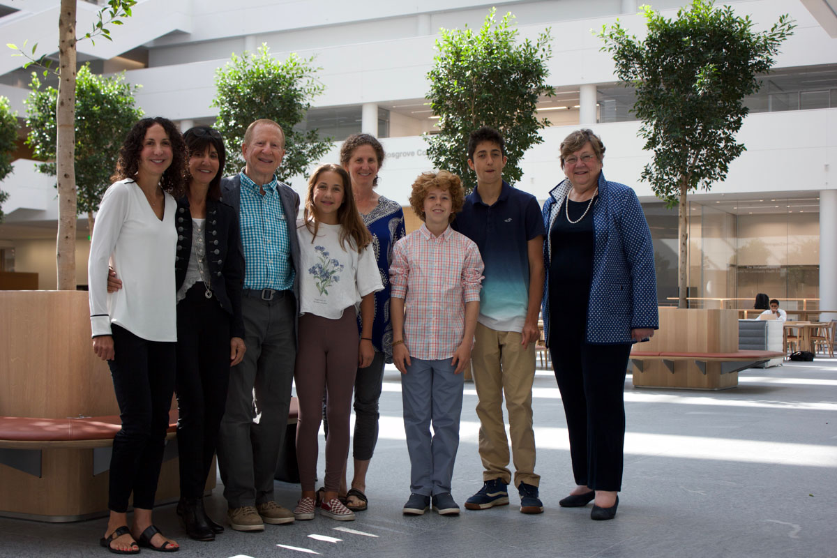 Photo line-up of Dr. Andrew Kaufman and his family with Dean Pamela Davis in the HEC